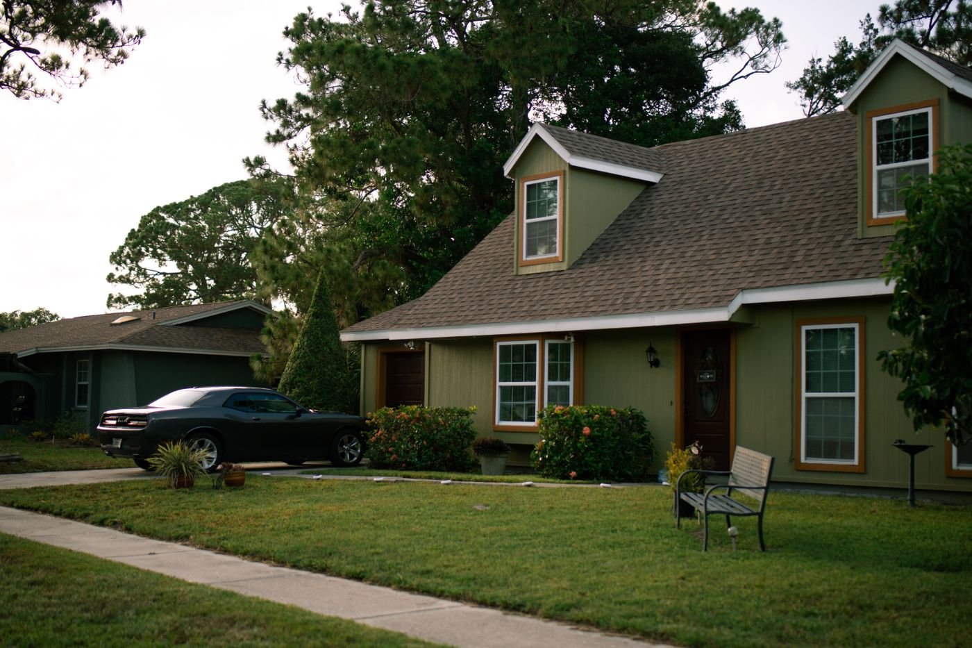 A beautiful suburban home with a well-maintained green lawn and parked car, highlighting residential comfort. — illustrative residential door hanger delivery photo for Visalia, CA